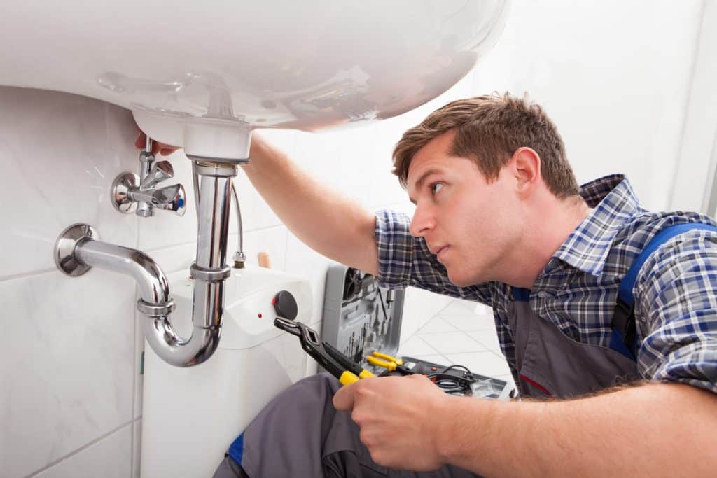 plumber fixing a sink