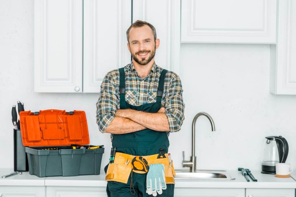 plumber standing in kitchen